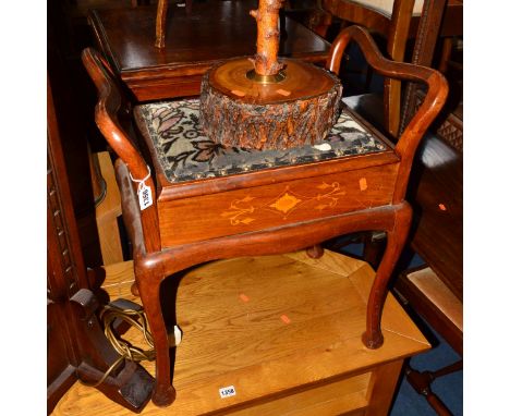 AN EDWARDIAN MAHOGANY AND INLAID PIANO STOOL, with shaped arms, on cabriole legs, containing a quantity of sheet music