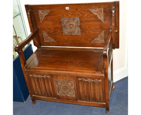 AN OAK LINENFOLD MONKS BENCH with a hinged lid