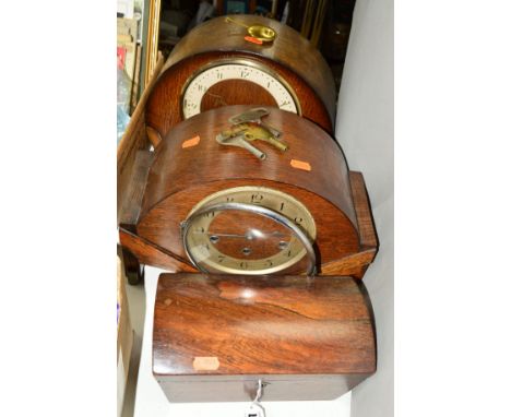 A VICTORIAN ROSEWOOD VENEERED DOME TOP TEA CADDY, approximate width 23cm, together with two oak dome top mantel clocks, one p