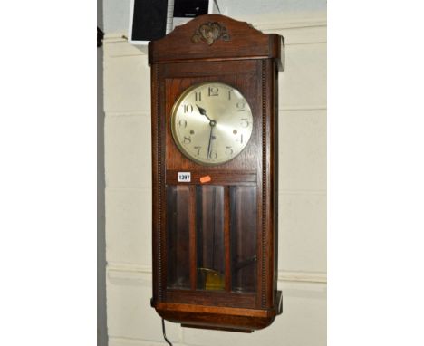 A MID 20TH CENTURY OAK WALL CLOCK (key and pendulum)