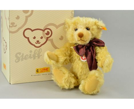 A BOXED STEIFF CLASSIC MILLENIUM TEDDY BEAR, blond mohair, No 003523, with bow, jointed limbs, approximate height 29cm, with 