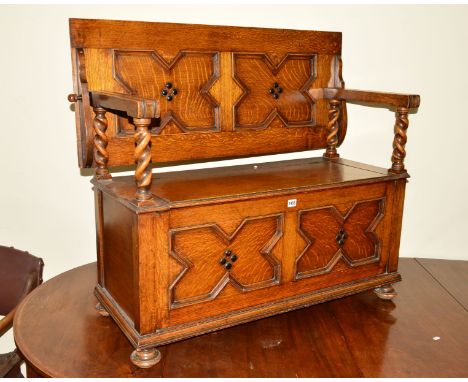 A 20TH CENTURY OAK BARLEY TWIST MONKS BENCH with hinged storage compartment, approximate width 107cm