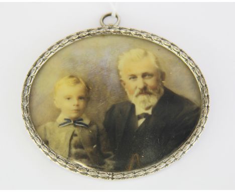 A white metal mounted hand painted portrait miniature of an elderly gentlemen and a boy, W. 8.5cm.