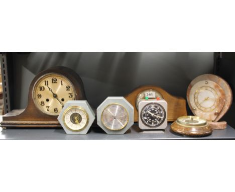 A group of vintage clocks and a barometer.
