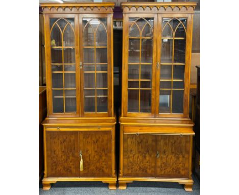 A pair of light walnut veneered contemporary bookcases with fitted cupboard below and wine glass slide, W. 75cm. H. 176cm.