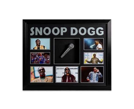 A professionally mounted, framed and glazed display to include a microphone signed in black ink by Snoop Dogg. Professionally