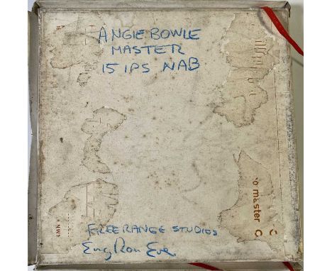 An Ampex 406 1/4" tape reel boxed in a Scotch 1/4" tape box that displays handwriting on the reverse of the box that says 'AN