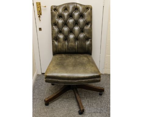A button back green leather swivel armchair