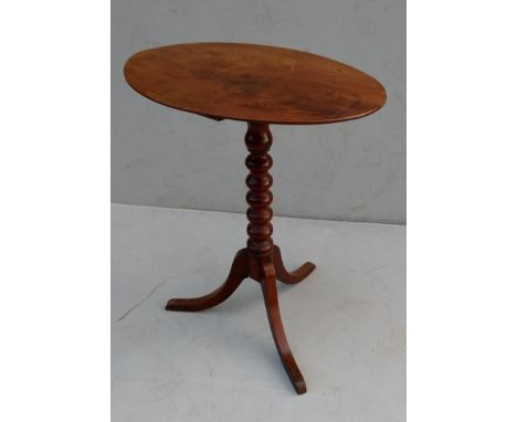 A Regency mahogany oval occasional table with bobbin support on a tripod base 