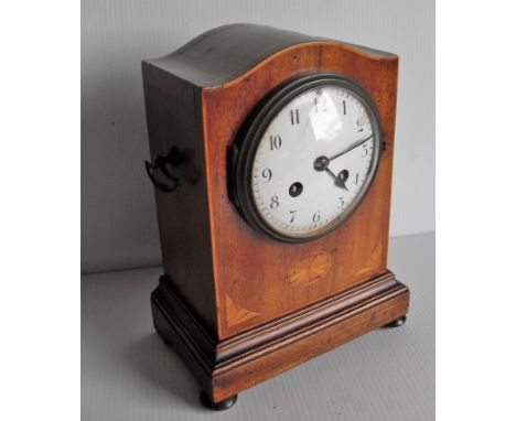 An Edwardian dome-topped mahogany-cased mantle clock with marquetry decoration, Arabic numerals, in working order but not kee