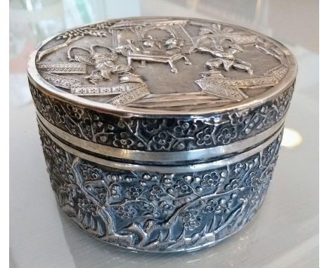 An early 20th century Chinese silver lidded circular box with prunus tree and court scene decoration by Wang Hing, Hong Kong,