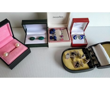 An assortment of silver cufflinks with enamel, diamond chips, etc