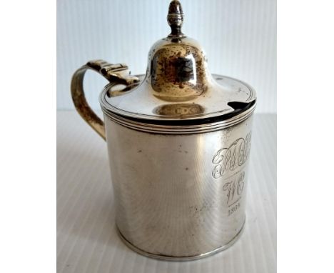 A George III silver mustard pot with blue glass liner of plain cylindrical form, acorn finial to lid, engraved dedication, by