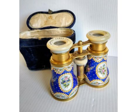 A cased pair of Edwardian gilt metal opera glasses with finely floral-enamelled barrels and mother-of-pearl fronted eye-piece