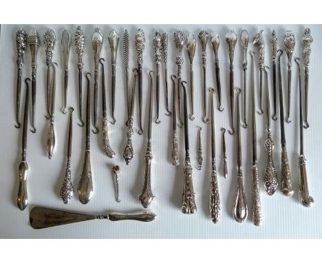 A selection of thirty-nine late 19th / early 20th century silver button hooks and one shoe horn, all hallmarked and in good c