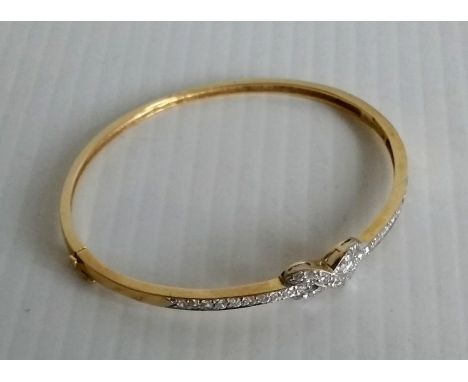 A 9ct gold bangle set with simulated diamonds and a 'Forever' knot 7.94g 