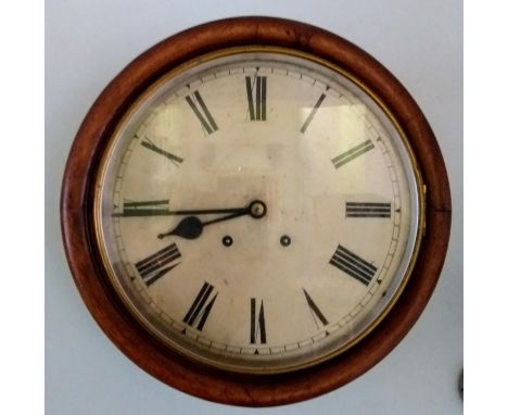 A 19th century circular wall clock with Roman numerals in mahogany frame, in working order with key