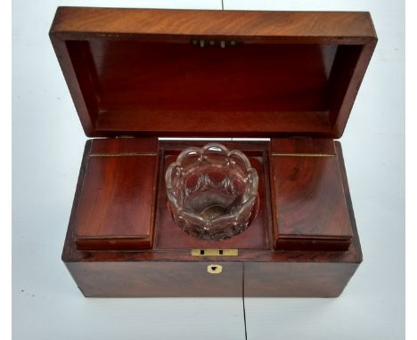 A Georgian mahogany tea caddy with twin internal compartments flanking a mixing glass bowl, 14 H x 30 W x 15 cm D