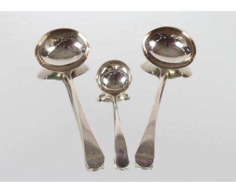 A pair of George III silver sauce ladles, monogrammed "M", London 1800; and a George V silver syrup ladle, Sheffield 1933, ap
