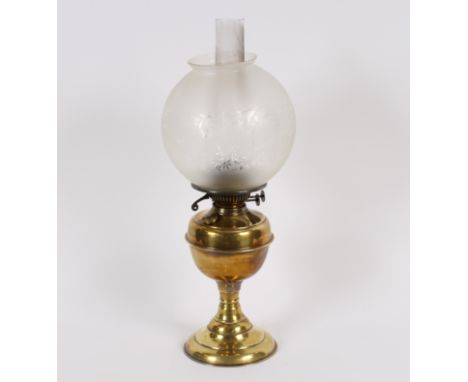 A Victorian brass column oil lamp with glass reservoir and tinted shade, 52cm high&nbsp;