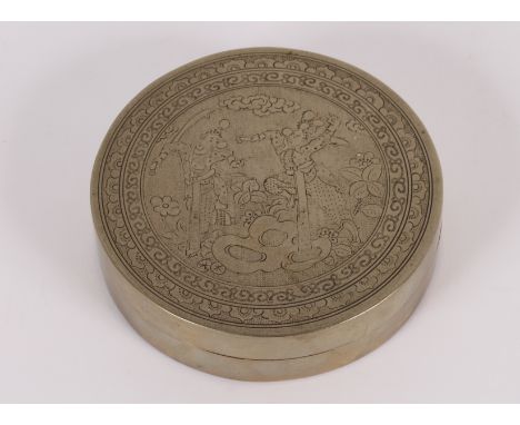 A 19th Century Chinese Paktong metal and copper inkstone box of circular form, engraved with figures in combat within floral 