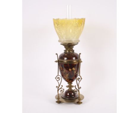 A Victorian brass and pottery oil lamp, with yellow tinted shade, 56cm high