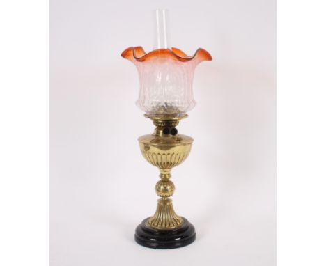 A Victorian brass table oil lamp, and an orange tinted glass shade, 59cm high overall