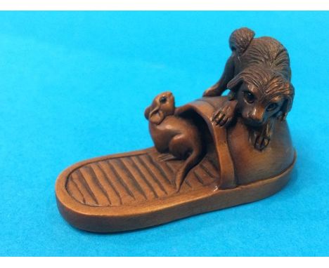 Netsuke; terrier chasing a rat on a slipper