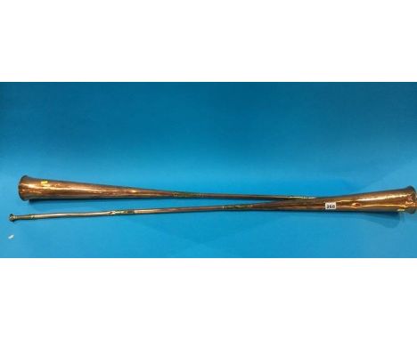 A pair of copper hunting horns, stamped London and York, George III, 123cm length 