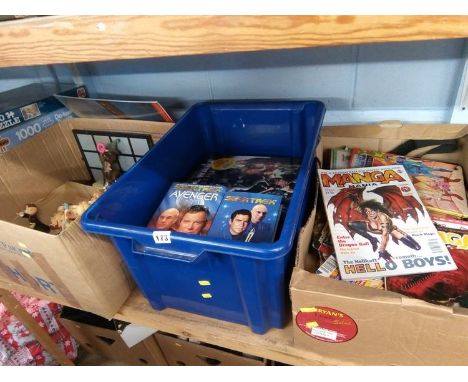 A shelf of figures, magazines and books