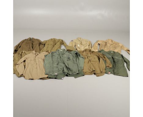 A varied collection of post Second World War military uniform shirts: A US Navy short sleeved dark green shirt with 's eabees