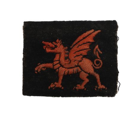 A 38th Division (Welsh) Arm Patch with a red dragon against a black ground. *CR Condition with slightly frayed edge.