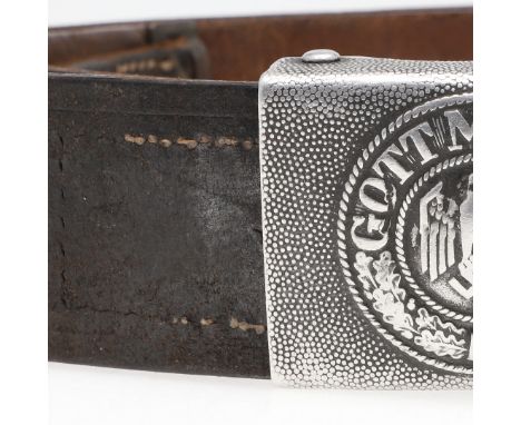 A Second World War German army die struck belt buckle 'Gott Mituns' dated 1938, with 4.5cm brown leather belt, the leather ta