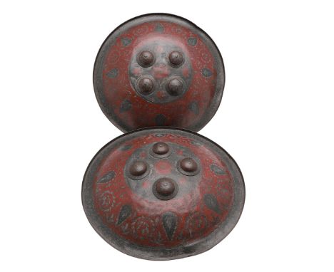 A pair of 19th century Indian Benares type circular shields, with raised 'buttons' to the centre, allover engraved decoration