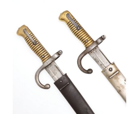 A bayonet and scabbard with a 57cm serpentine blade with broad back, engraved for Hekelin Bitschiviller (?) February 1868, wi