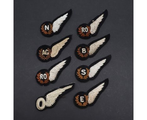 A collection of single wing 'Brevet' badges: AG (Air gunner), E (Engineer), N (Navigator), O (Observer), RO (Radio observer) 