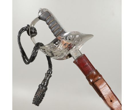 An 1897 Pattern Infantry Officers sword with an 83cm pointed unsharpened blade with etched decoration, with badge for the Oxf