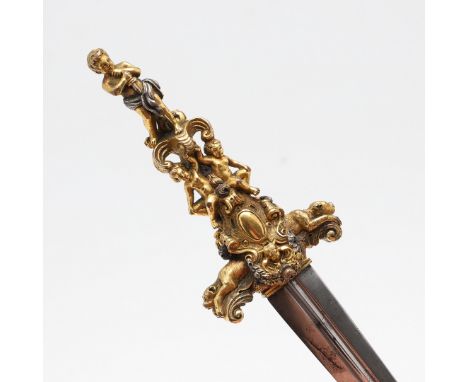 With a 12.5cm pointed double edged blade with central shallow fullers, on an elaborate gilt handle with an arrangement of che