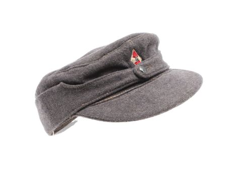 A light grey Hitler Youth winter 's ki' type cap, the sides fastened by a single button, with an embroidered Hitler youth bad
