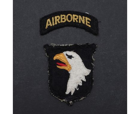 A two part 101st Airborne shoulder patch with 'Airborne' over a shield with a white eagle with open beak. The shield 6 x 5.5c