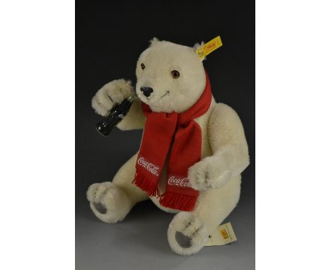 Steiff - a Coca-Cola Polar Bear, No 654831, white body, glass eyes, red scarf, cola bottle to paw, modelled seated, yellow ea