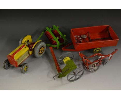 Mettoy - a tinplate clockwork Tractor and farm implements set - inc a Tractor, yellow and red body, with grey plastic engine 