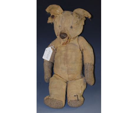 An early 20th century Steiff jointed bear, stud to ear, 40cm high, playworn, c.1910