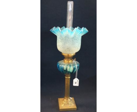 Early 20th Century brass oil lamp with coloured glass reservoir and brass pedestal base, etched glass shade and clear chimney