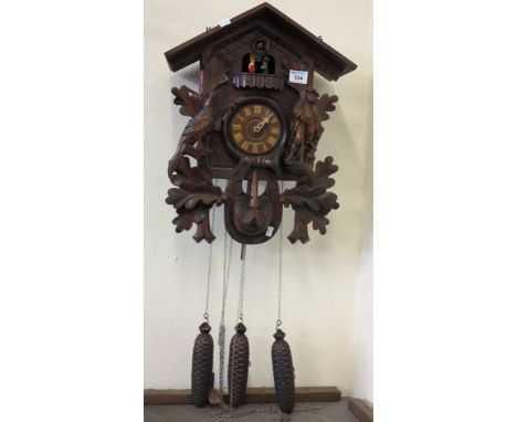 Bavarian carved oak cuckoo clock with figural and bird decoration and three train movement. (B.P. 24% incl. VAT) 