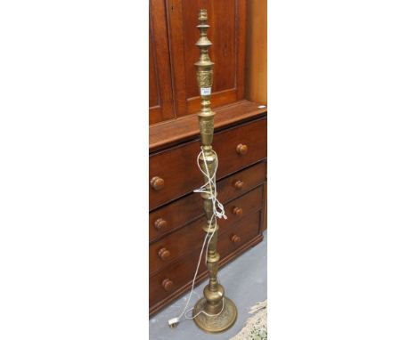 Eastern design brass standard lamp decorated with bands of stylised animals on circular base. (B.P. 24% incl. VAT)