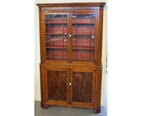 Victorian mahogany two stage cabinet having moulded cornice over two glazed doors with fitted shelves to the interior, the ba