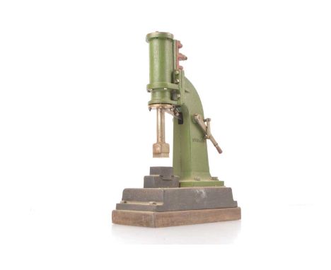 A Model Steam Press/Hammer by Stuart Models, on a heavy cast base and wooden plinth, the machine standing 9" high, the single