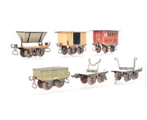 A Group of very early Marklin 4-wheeled Rolling Stock, all with dark green axlebox trunnions, comprising a coach in red with 