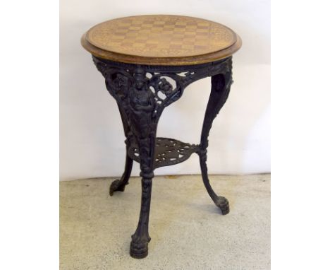 Cast iron pub table with replacement top in the form of a chess board
